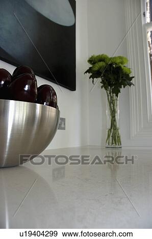 Close-up of stainless steel bowl and small flower arrangement on granite worktop View Large Photo Image Stock Photo - Close-up of stainless steel bowl and small flower arrangement on granite worktop. Fotosearch