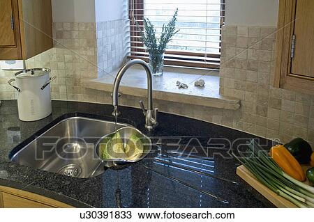 Close-up of stainless steel Franke undermounted sink and stainless steel tap in black granite worktop View Large Photo Image Stock Image - Close-up of stainless steel Franke undermounted sink and stainless steel tap in black granite worktop. Fotosearch