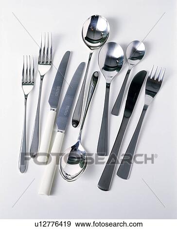 Stock Photo - Close-up of stainless steel knives and forks with spoons. Fotosearch
