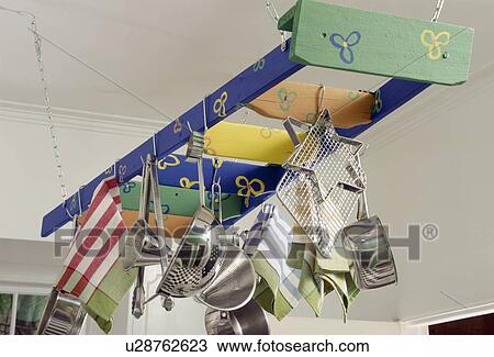 Close-up of stainless steel pans and utensils on brightly painted storage rack View Large Photo Image Stock Image - Close-up of stainless steel pans and utensils on brightly painted storage rack. Fotosearch