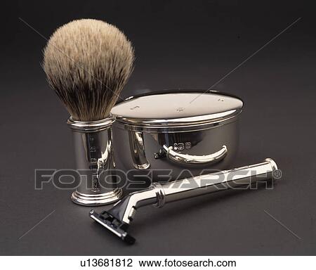 Stock Image - Close-up of stainless steel razor with badger-hair brush and steel soap-dish. Fotosearch