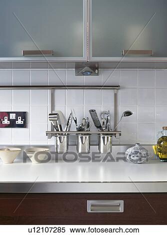 Stock Photography - Close-up of stainless-steel shelf with steel pots storing kitchen utensils. Fotosearch