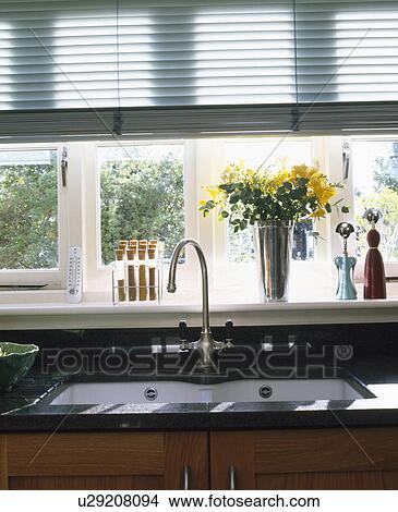 Close-up of stainless steel tap and underset sink below window with slatted blind View Large Photo Image Picture - Close-up of stainless steel tap and underset sink below window with slatted blind. Fotosearch