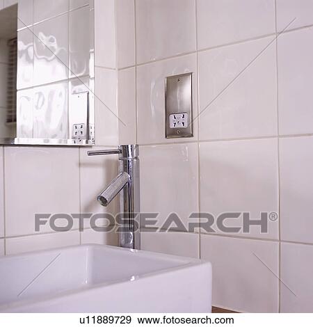 Close-up of stainless steel tap and modern white basin below electric plug socket View Large Photo Image Stock Photo - Close-up of stainless steel tap and modern white basin below electric plug socket. Fotosearch