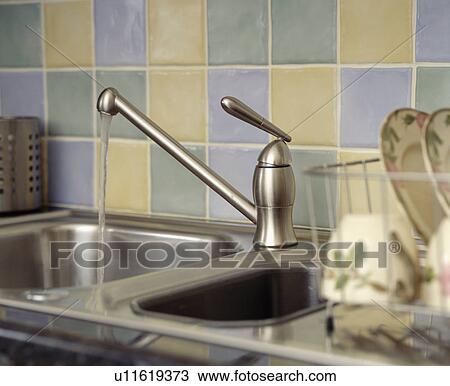 Close-up of stainless steel tap pouring water into double steel sink View Large Photo Image Stock Image - Close-up of stainless steel tap pouring water into double steel sink. Fotosearch