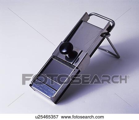 Stock Photo - Close-up of stainless-steel vegetable slicer. Fotosearch
