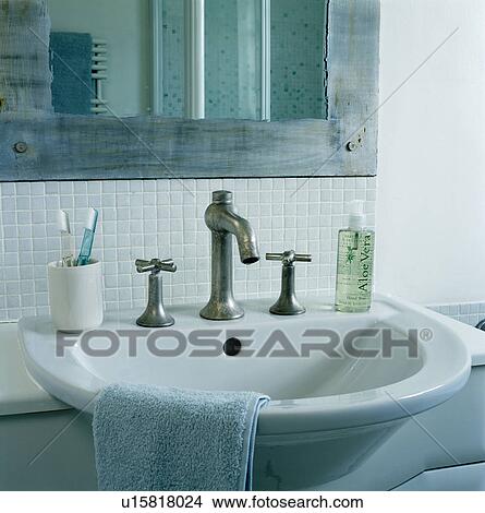 Picture - Close-up of steel taps and white basin. Fotosearch