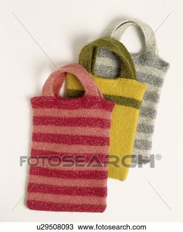 Stock Image - Close-up of striped felted wool bags. Fotosearch