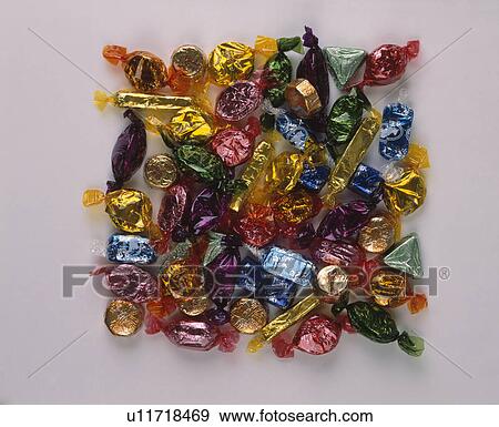 Stock Photo - close-up of sweets in multi-coloured cellophane wrappers. Fotosearch