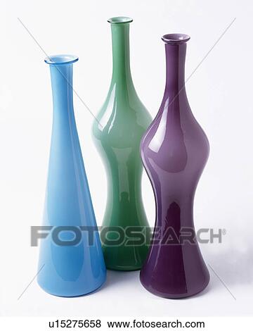 Close-up of tall blue and purple glass vases with green vase View Large Photo Image Stock Photo - Close-up of tall blue and purple glass vases with green vase. Fotosearch