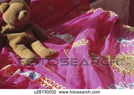 Close-up of teddybear on embroidered pink Indian bedcover View Large Photo Image Stock Image - Close-up of teddybear on embroidered pink Indian bedcover. Fotosearch