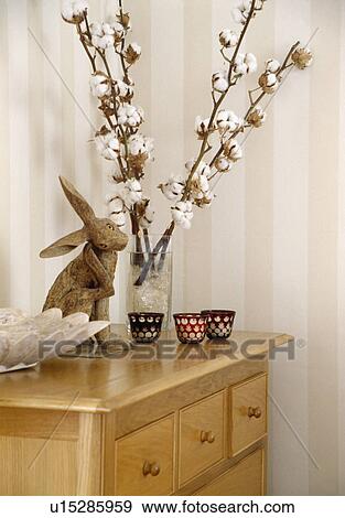 Stock Photo - Close-up of terracotta rabbit and cotton flowers. Fotosearch