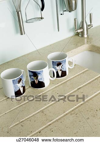 Close-up of three cups on beige granite draining board View Large Photo Image Stock Photo - Close-up of three cups on beige granite draining board. Fotosearch