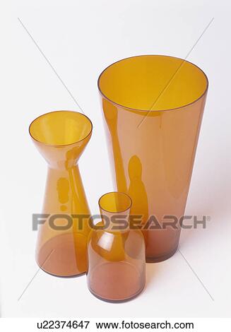 Stock Photo - Close-up of three shaped orange vases. Fotosearch