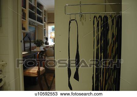 Stock Image - Close-up of ties on storage rack. Fotosearch