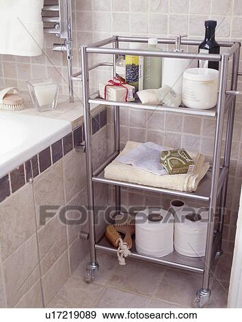 Stock Photo - Close-up of toiletries and toilet rolls on stainless steel shelf unit. Fotosearch