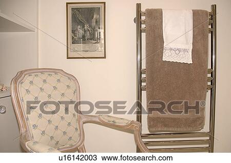 Close-up of traditional chair beside stainless-steel radiator in modern bathroom View Large Photo Image Stock Image - Close-up of traditional chair beside stainless-steel radiator in modern bathroom. Fotosearch