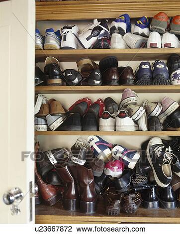 Close-up of trainers and shoes on wooden shelves View Large Photo Image Stock Image - Close-up of trainers and shoes on wooden shelves. Fotosearch