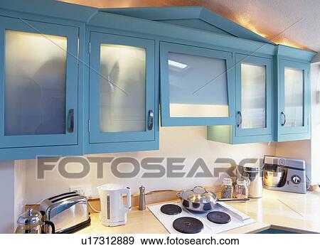 Close-up of turquoise fitted cupboard with glazded doors View Large Photo Image Stock Photo - Close-up of turquoise fitted cupboard with glazded doors. Fotosearch