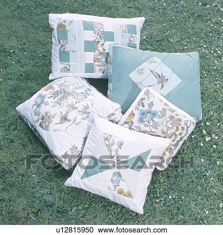 Stock Image - Close-up of turquoise patchwork cushions. Fotosearch
