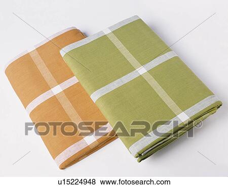 Close-up of two folded orange and green checked tablecloths View Large Photo Image Stock Photo - Close-up of two folded orange and green checked tablecloths. Fotosearch