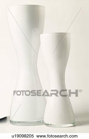 Close-up of two modern white opaque glass vases View Large Photo Image Stock Photography - Close-up of two modern white opaque glass vases. Fotosearch