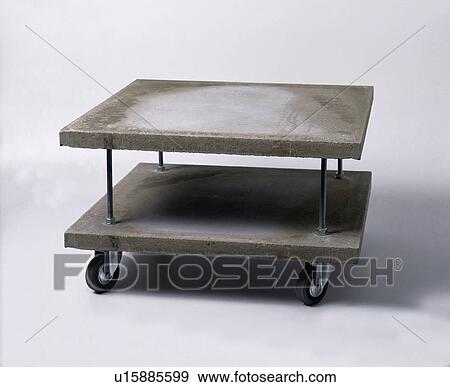 Close-up of two-tiered modern stone table on castors View Large Photo Image Stock Photo - Close-up of two-tiered modern stone table on castors. Fotosearch