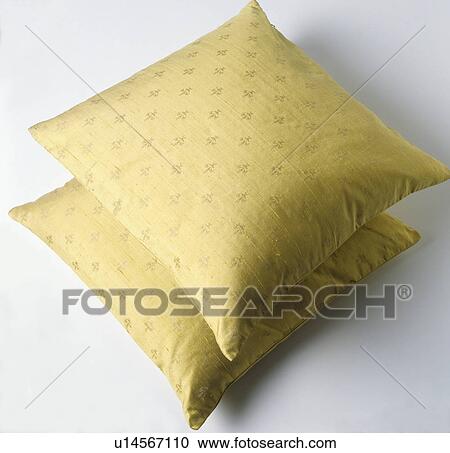Stock Image - Close-up of two yellow silk cushions. Fotosearch