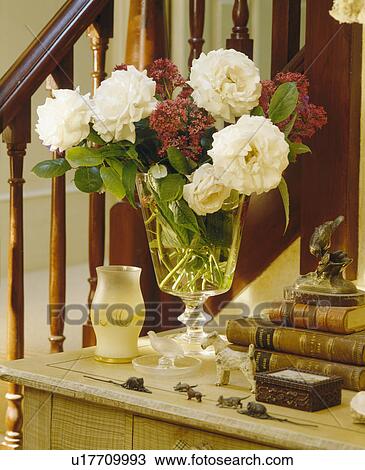 Close-up of vase of cream roses on hall table View Large Photo Image Stock Image - Close-up of vase of cream roses on hall table. Fotosearch