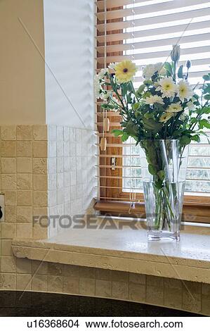 Close-up of vase of white flowers on limestone window-sill View Large Photo Image Picture - Close-up of vase of white flowers on limestone window-sill. Fotosearch