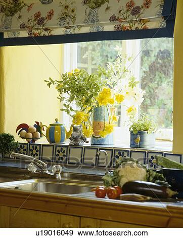 Close-up of vegetables on worktop beside sink below window with flowers on window-sill View Large Photo Image Stock Photo - Close-up of vegetables on worktop beside sink below window with flowers on window-sill. Fotosearch