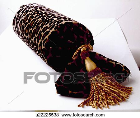 Close-up of velvet animal-print bolster cushion with gold and brown silk tassel View Large Photo Image Stock Photo - Close-up of velvet animal-print bolster cushion with gold and brown silk tassel. Fotosearch