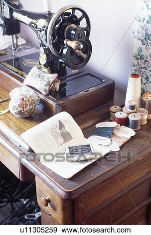 Close-up of vintage Singer sewing-machine with cotton reels on wooden table View Large Photo Image Stock Photo - Close-up of vintage Singer sewing-machine with cotton reels on wooden table. Fotosearch
