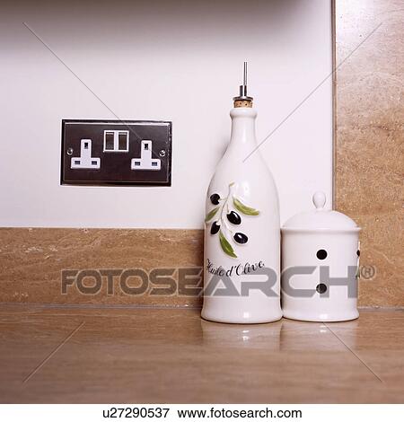 Close-up of white ceramic olive oil jar below electric plug socket View Large Photo Image Stock Photo - Close-up of white ceramic olive oil jar below electric plug socket. Fotosearch
