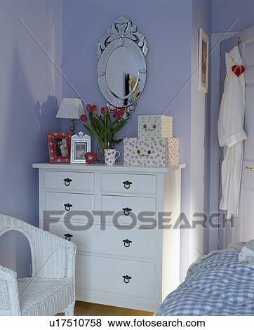 Close-up of white chest-of-drawers in blue country bedroom View Large Photo Image Stock Photo - Close-up of white chest-of-drawers in blue country bedroom. Fotosearch