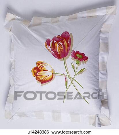 Stock Photograph - Close-up of white cushion hand-painted with red tulips. Fotosearch