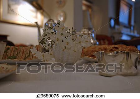 Close-up of white floral arrangement on table set for tea View Large Photo Image Stock Photography - Close-up of white floral arrangement on table set for tea. Fotosearch