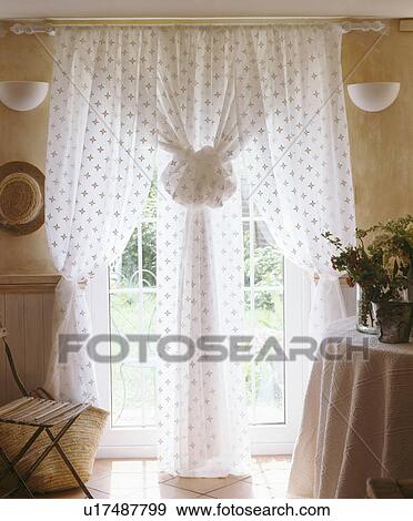 Stock Photo - Close-up of white voile curtains at French window. Fotosearch