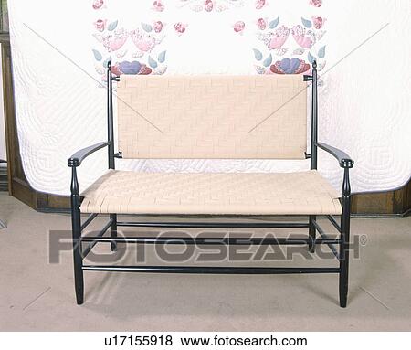Stock Photo - Close-up of wooden sofa with woven cream seat and back. Fotosearch