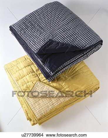 Close-up of yellow and blue folded quilts View Large Photo Image Picture - Close-up of yellow and blue folded quilts. Fotosearch