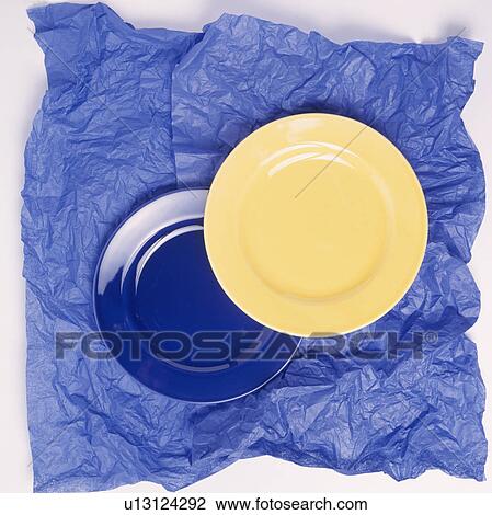 Close-up of yellow and blue plates on blue tissue paper View Large Photo Image Stock Image - Close-up of yellow and blue plates on blue tissue paper. Fotosearch