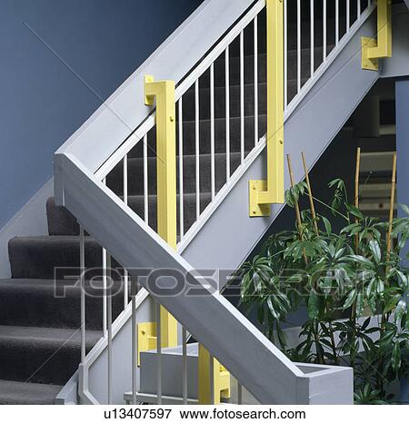 Stock Photo - Close-up of yellow and pastel blue staircase. Fotosearch