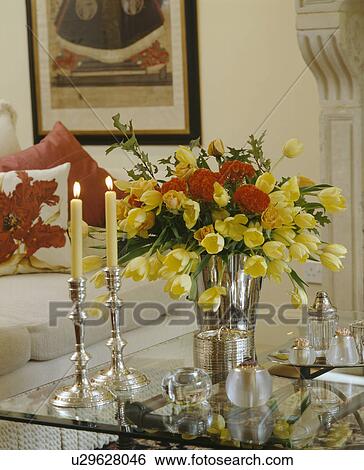 Close-up of yellow tulips in vase on glass table View Large Photo Image Stock Photograph - Close-up of yellow tulips in vase on glass table. Fotosearch