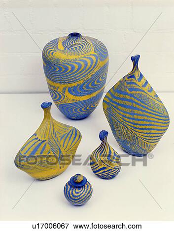 Stock Photo - Close-up of yellow+blue swirly-patterned glass ornaments. Fotosearch