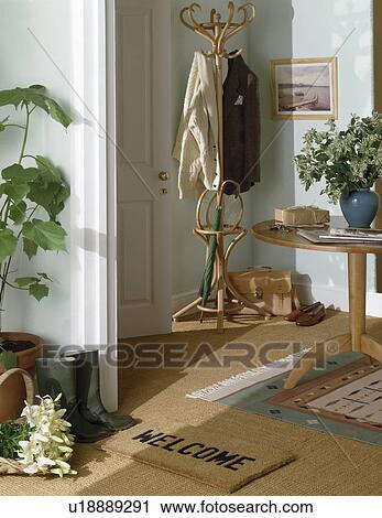 Clothes on bentwood stand in hall with welcome mat and sisal carpet View Large Photo Image Stock Image - Clothes on bentwood stand in hall with welcome mat and sisal carpet. Fotosearch