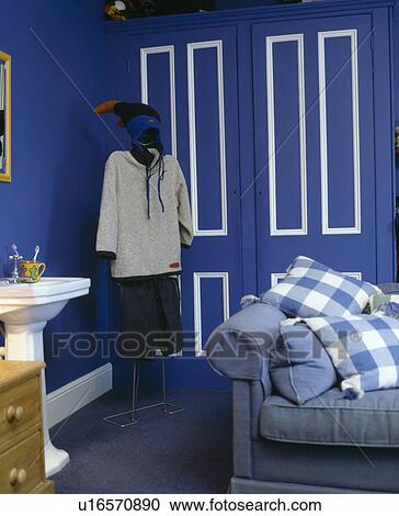 Clothes on mannequin in blue bedroom with white basin and blue sofa View Large Photo Image Stock Image - Clothes on mannequin in blue bedroom with white basin and blue sofa. Fotosearch