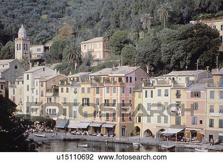Colourful houses below wooden hillside along the shore in the port of Portofino in Italy View Large Photo Image Stock Image - Colourful houses below wooden hillside along the shore in the port of Portofino in Italy. Fotosearch