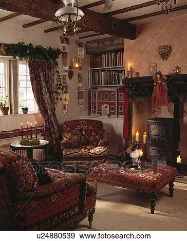 Stock Photo - Comfortable cottage living room decorated for Christmas. Fotosearch