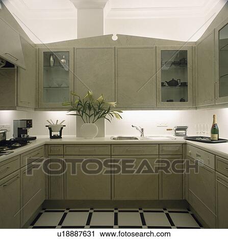 Compact modern kitchen with underlit fitted cupboards View Large Photo Image Stock Image - Compact modern kitchen with underlit fitted cupboards . Fotosearch