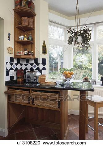 Corner shelves above breakfast bar with granite worktop in country kitchen View Large Photo Image Stock Image - Corner shelves above breakfast bar with granite worktop in country kitchen. Fotosearch